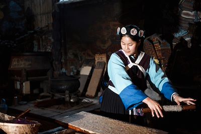 Femme Naxi confectionnnant du papier - Chine